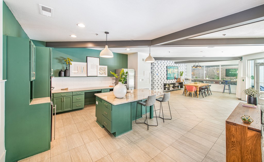 a kitchen with green cabinets and a white counter top