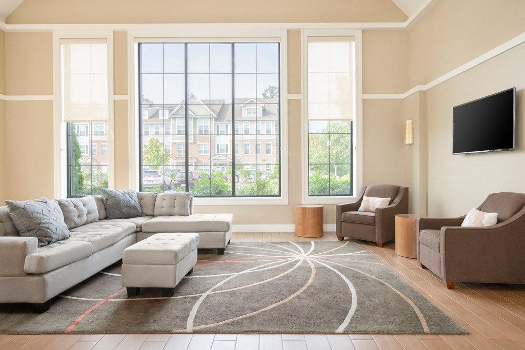 a living room with a large window and a large couch