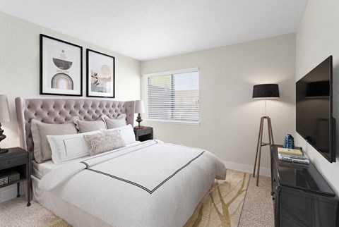 a bedroom with picture frames on the wall