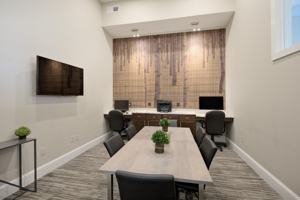 a meeting room with a table and chairs