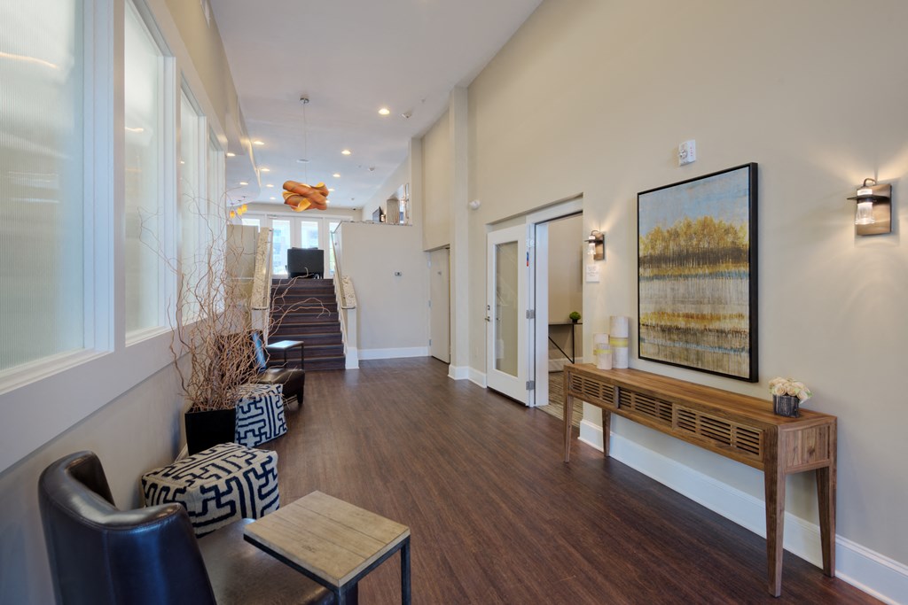 a living room with hardwood floors and white walls
