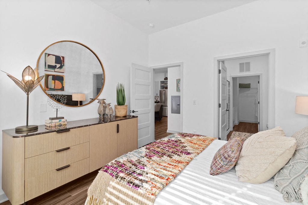 a bedroom with a bed and a mirror