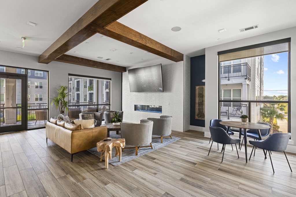 A modern living room with a wooden floor and a large window.