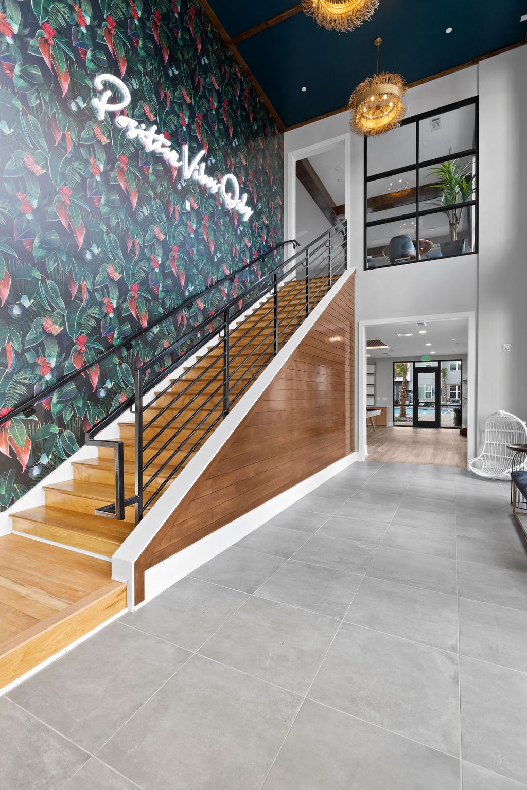 Stairway with Neon lettering on wallpaper