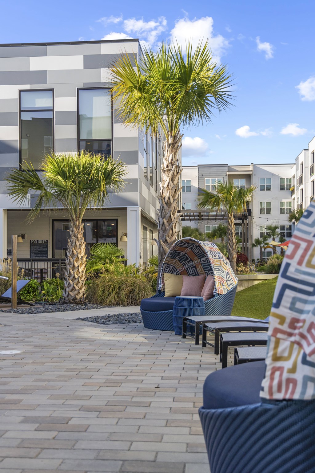 A modern building with a palm tree in front.