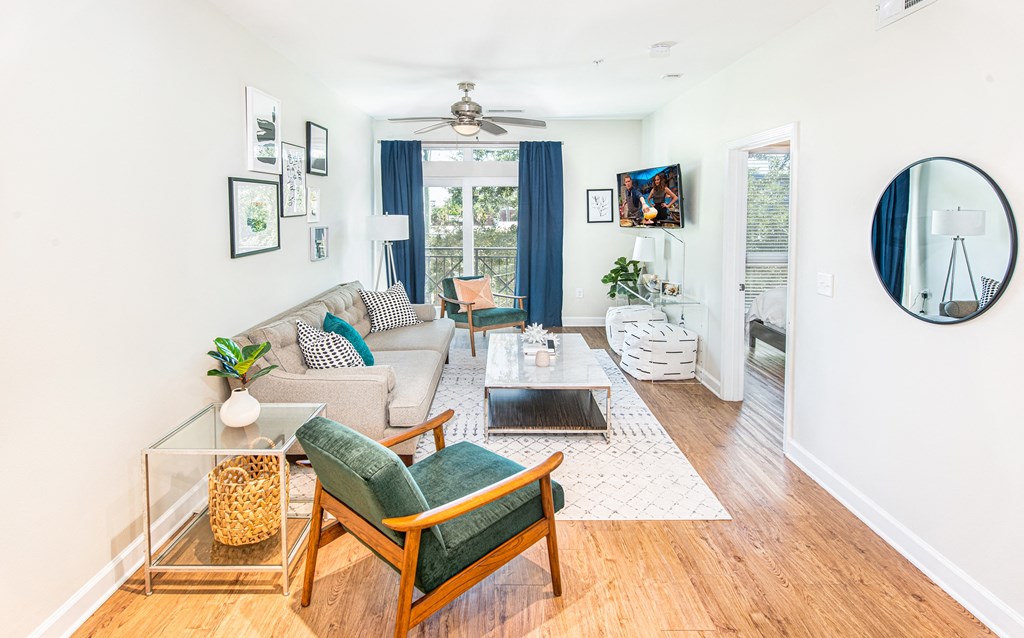 a living room with white walls and blue curtains