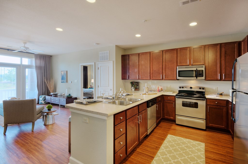 a kitchen with wooden cabinets and a white counter top