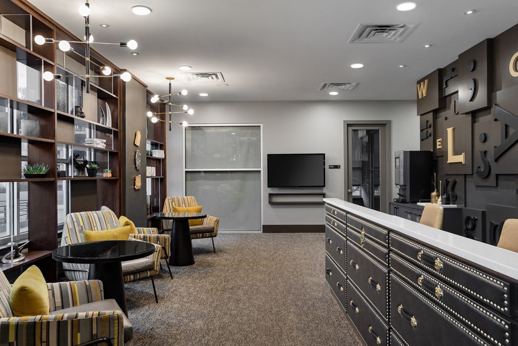 a lounge area with chairs and a television in a room