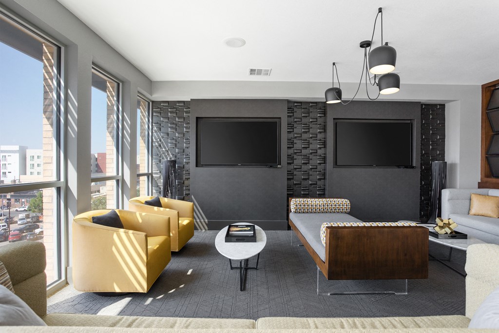 a living room with couches and chairs and a television