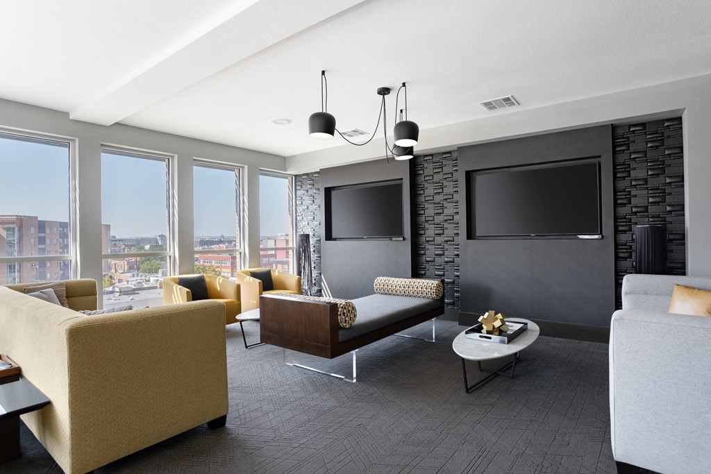 a living room with couches and chairs and a television