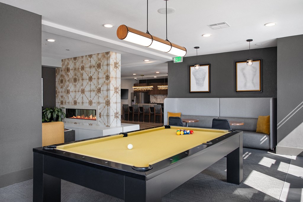 a games room with a pool table and a fireplace