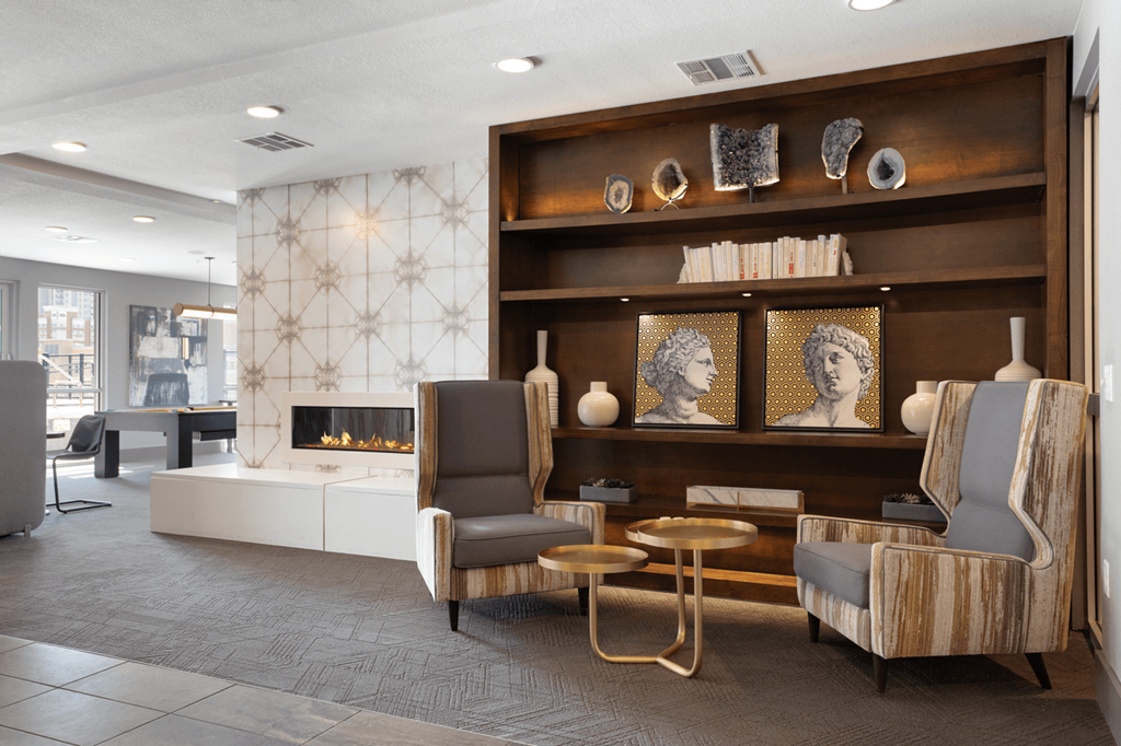 a living room with two chairs and a fireplace