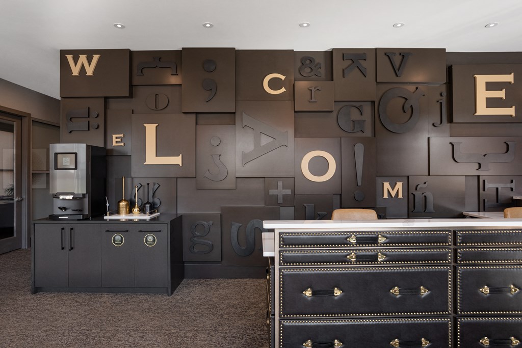 a lobby with a dresser and a wall with letters on it