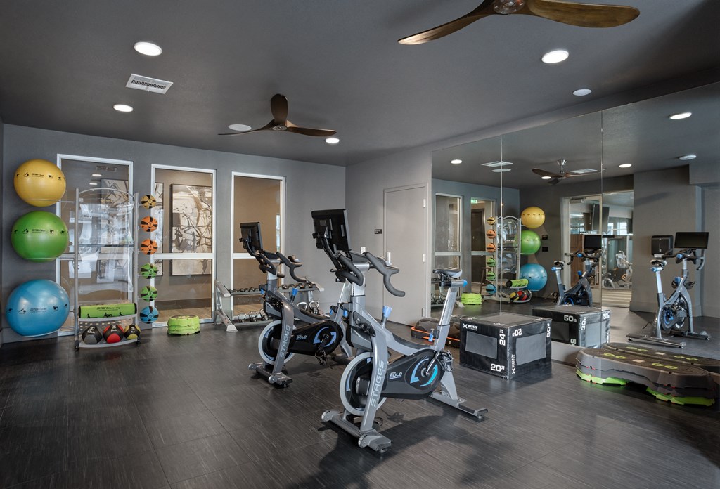 a home gym with exercise bikes and other fitness equipment