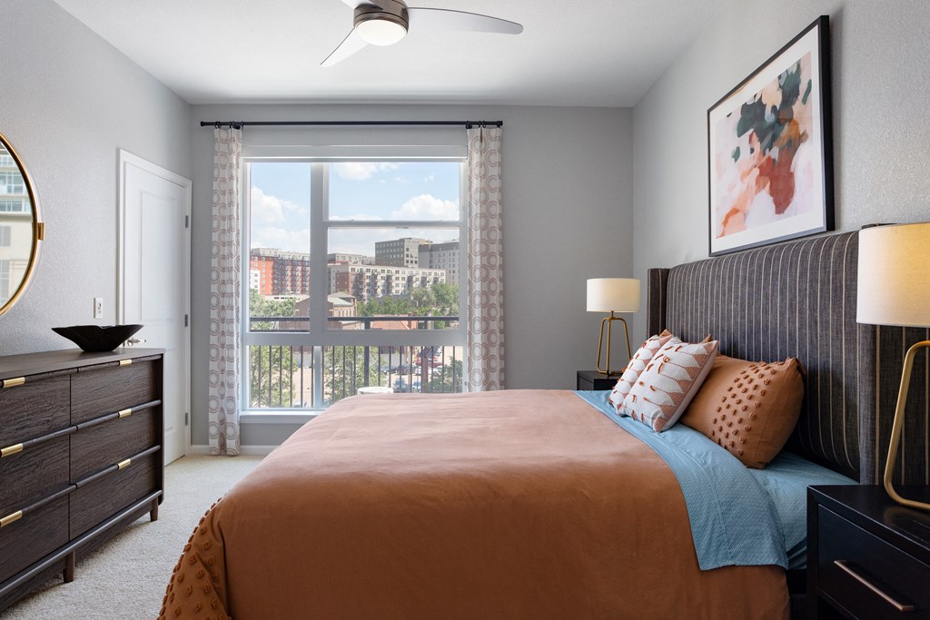 a bedroom with a large bed and a window