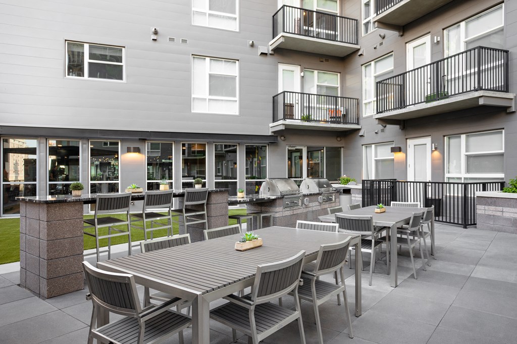 a dining area with tables and chairs in a courtyard
