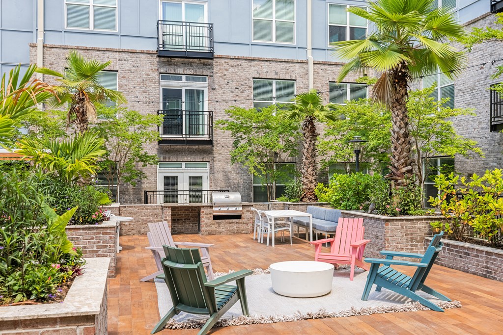 a patio with chairs and a fire pit at the bradley braddock road station apartments