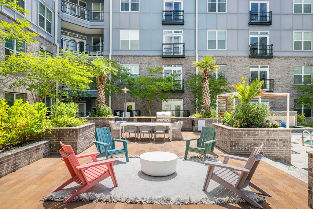an outdoor patio with chairs and a firepit