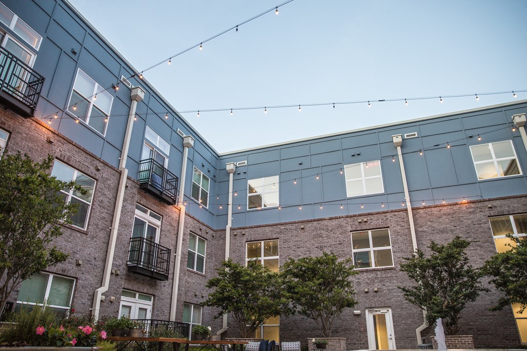 a view of the outside of a building with string lights