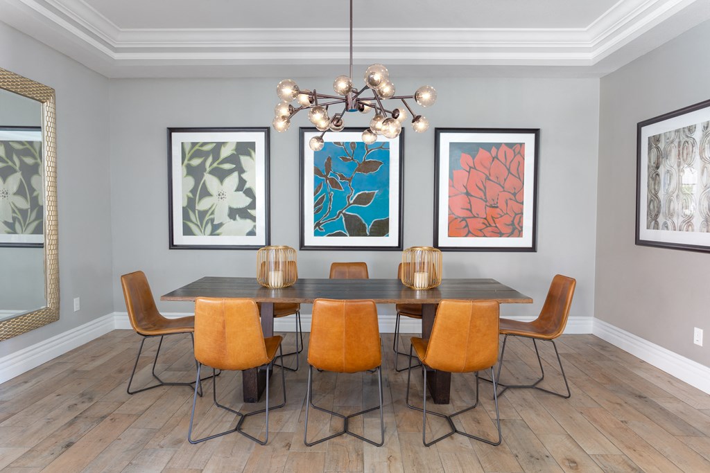 a dining room with a table and chairs and a chandelier