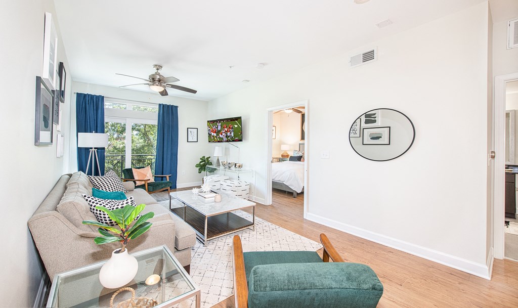 a living room with white walls and blue curtains