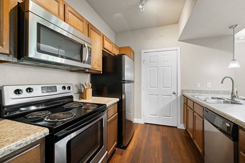 A kitchen with a black stove top oven and a black refrigerator.