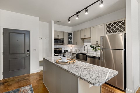 a kitchen with stainless steel appliances and granite counter tops