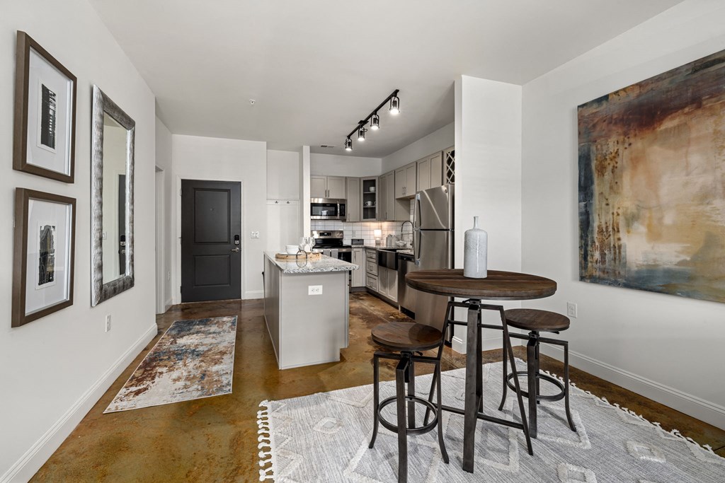 a kitchen with white walls and a wooden floor