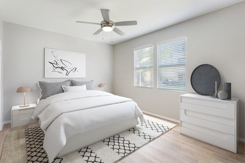 a bedroom with a white bed and white dresser