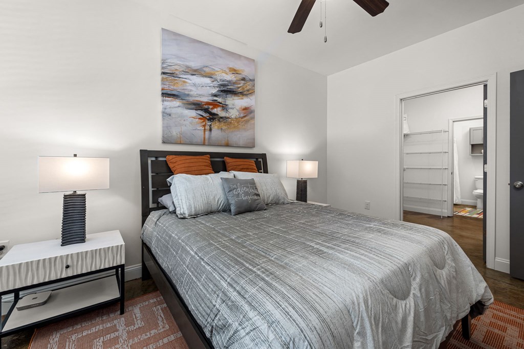 a bedroom with a bed and a ceiling fan