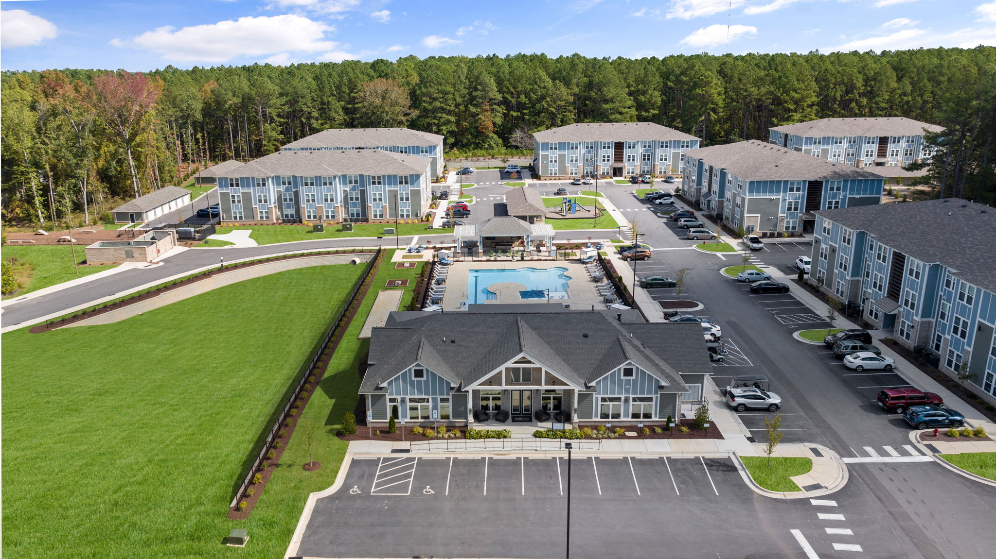 an aerial view of an apartment complex with a swimming pool