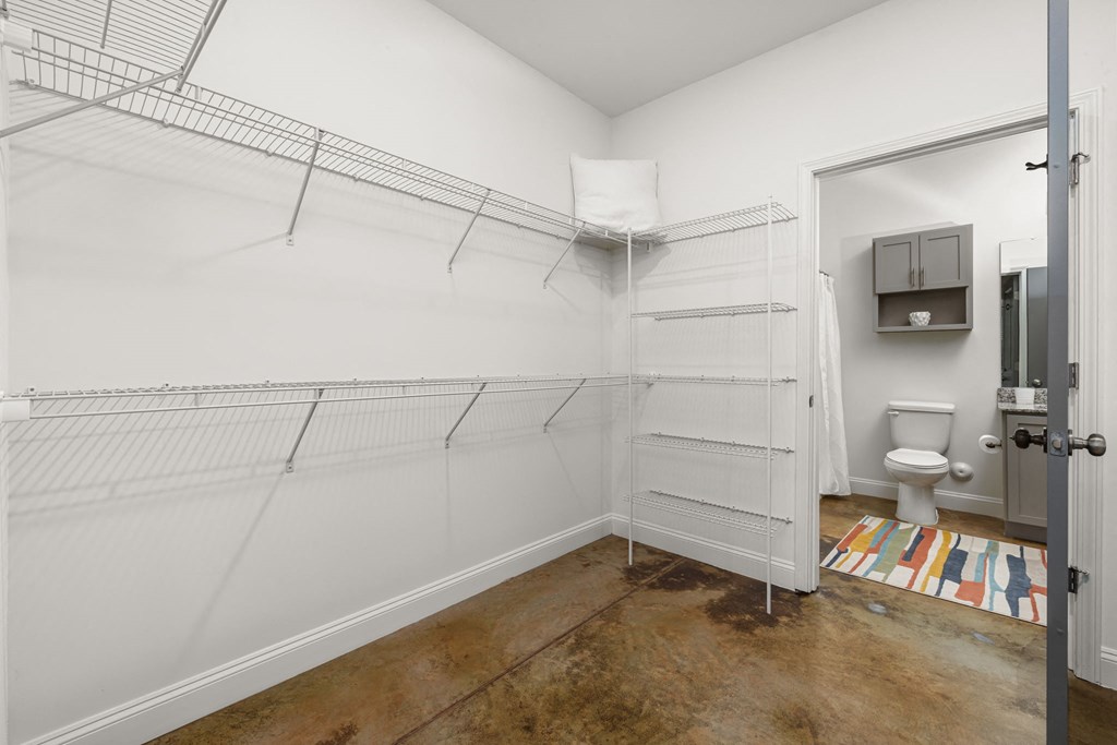 a bathroom with white walls and a white toilet next to a white sink