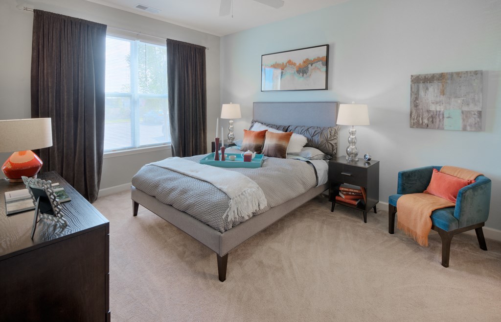 a bedroom with a bed and a chair in a 555 waverly unit