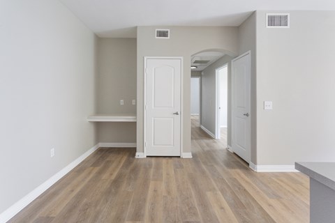 a living room with hardwood floors and grey walls