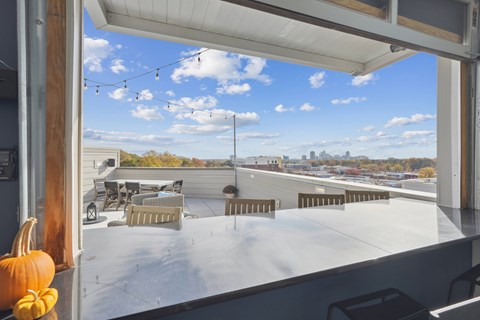 A pumpkin is sitting on a table in front of a window.