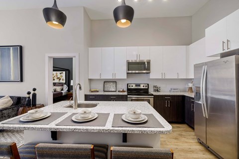 a kitchen with a counter top with plates on it