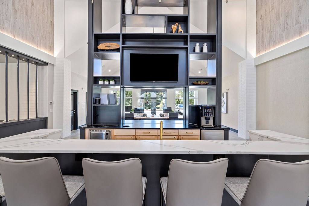 a kitchen with a table and chairs and a television
