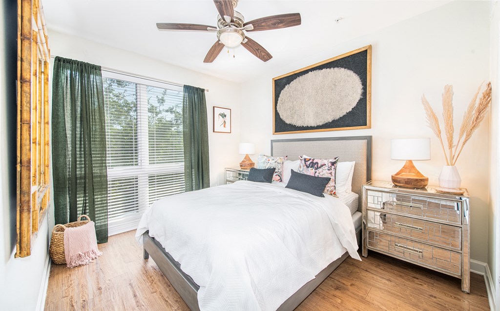 a bedroom with a large bed and a ceiling fan