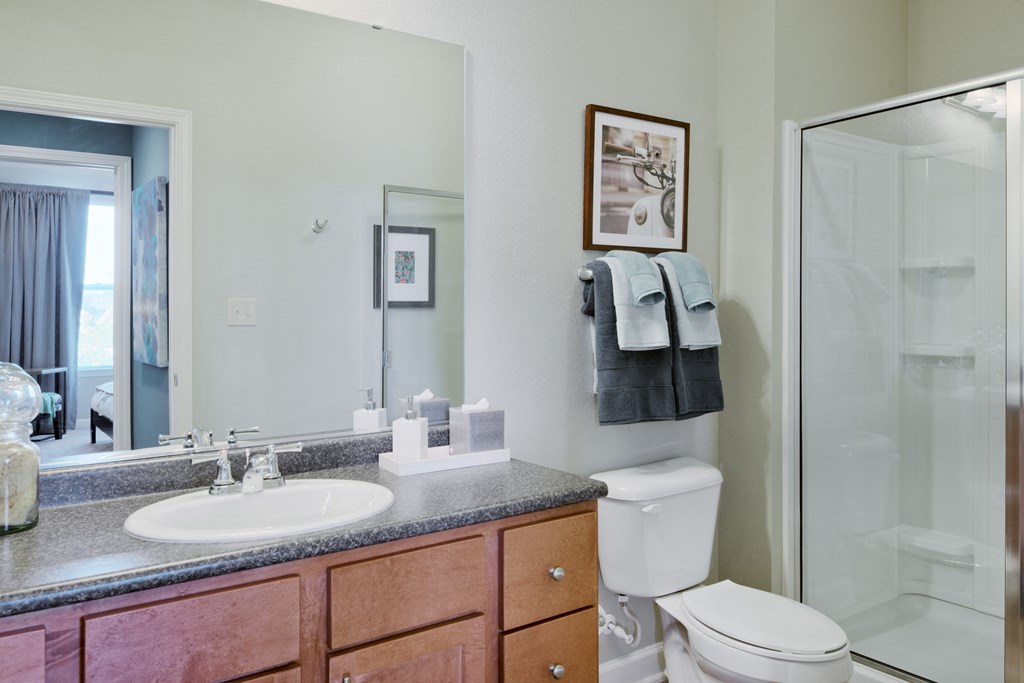 a bathroom with a sink toilet and shower