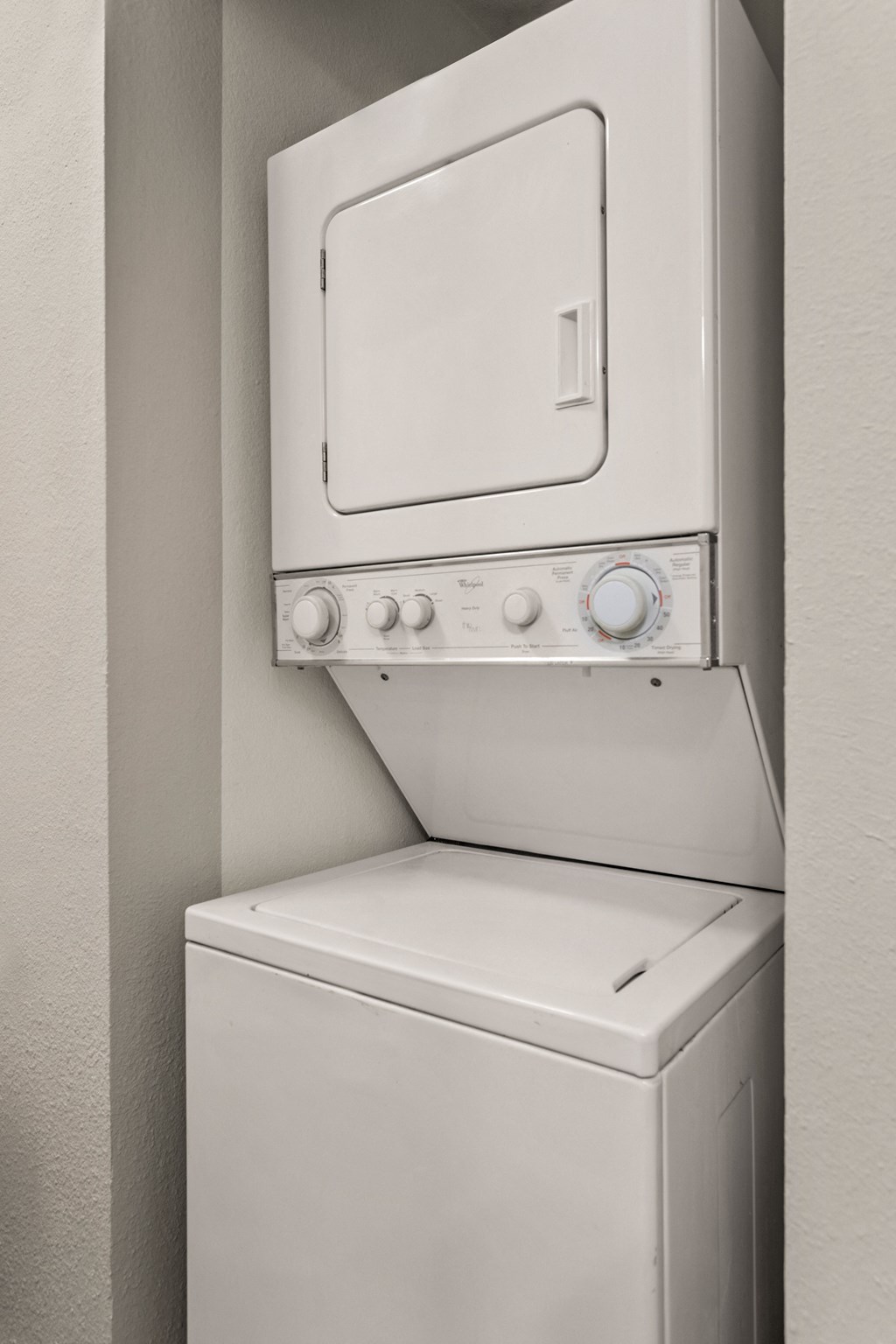 a washer and dryer in an empty laundry room