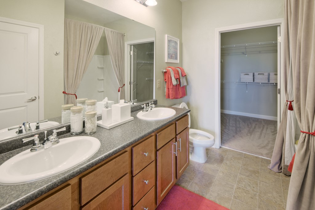 a bathroom with two sinks and a shower