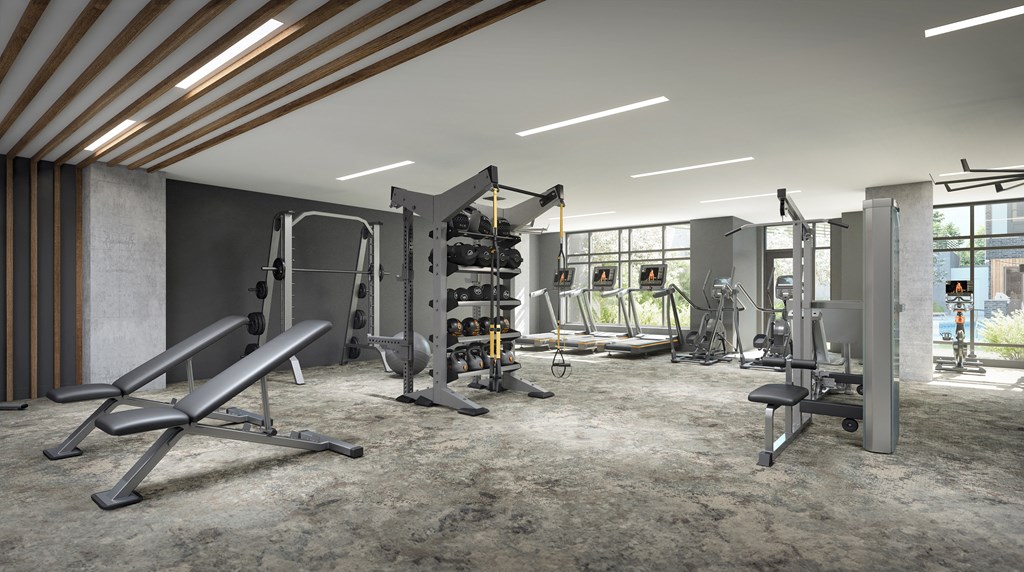 a workout room with fitness equipment and windows in a building