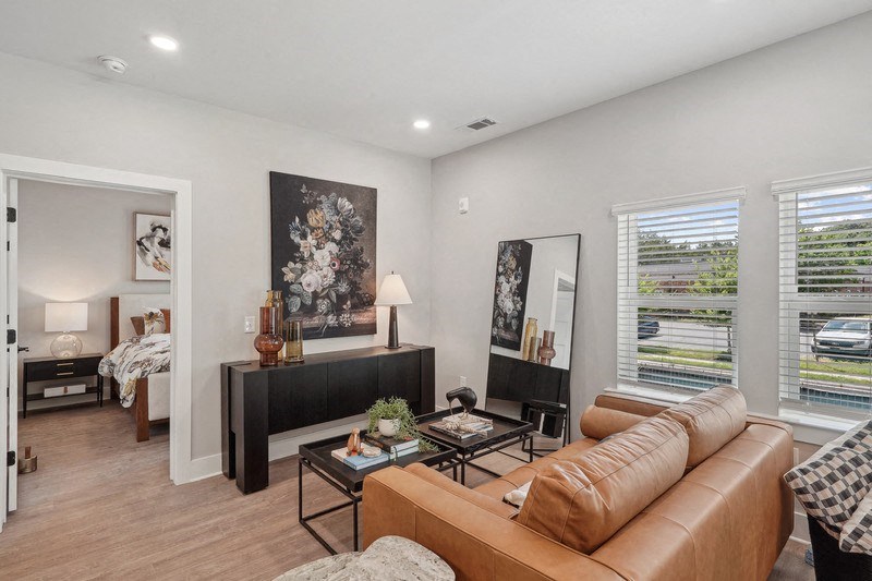 the living room of an apartment with a couch and a coffee table