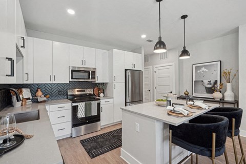 an open kitchen and dining area with a table and chairs
