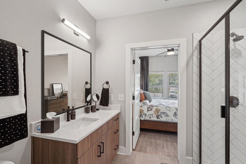 a bathroom with a large mirror and a sink