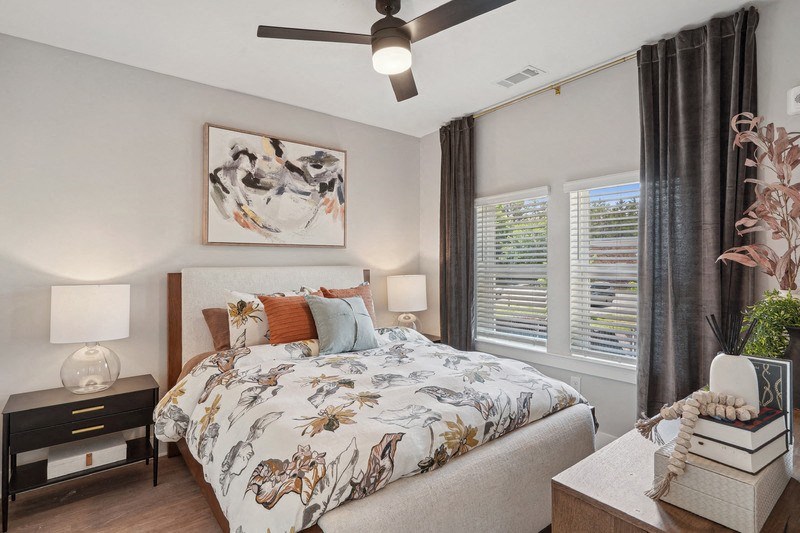 a bedroom with a bed and a ceiling fan