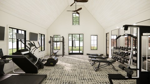 A spacious gym with a variety of equipment and a ceiling fan.