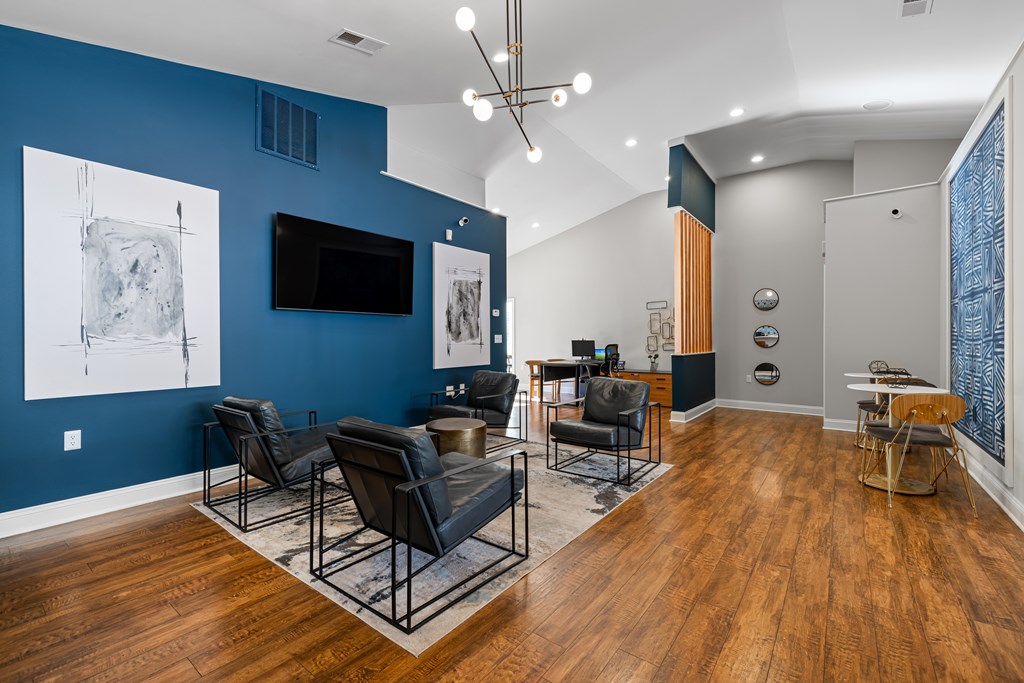 A living room with a blue wall and a television.