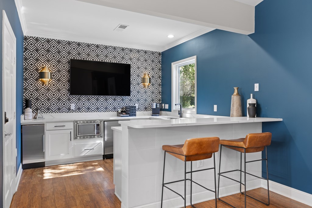 A kitchen with blue walls and white countertops.