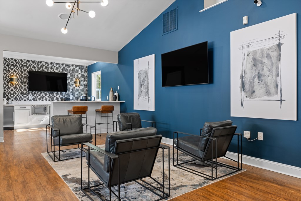 A living room with a blue wall and a television.